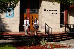 2 students walking down steps of chapel